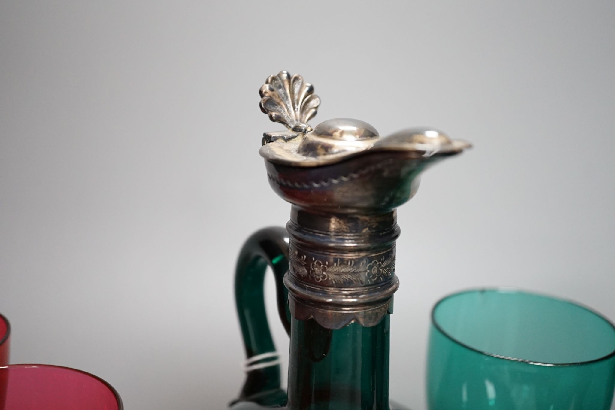A Victorian dark green glass hock jug, five dark green wine glasses and 6 cranberry bowled wine glasses (12)